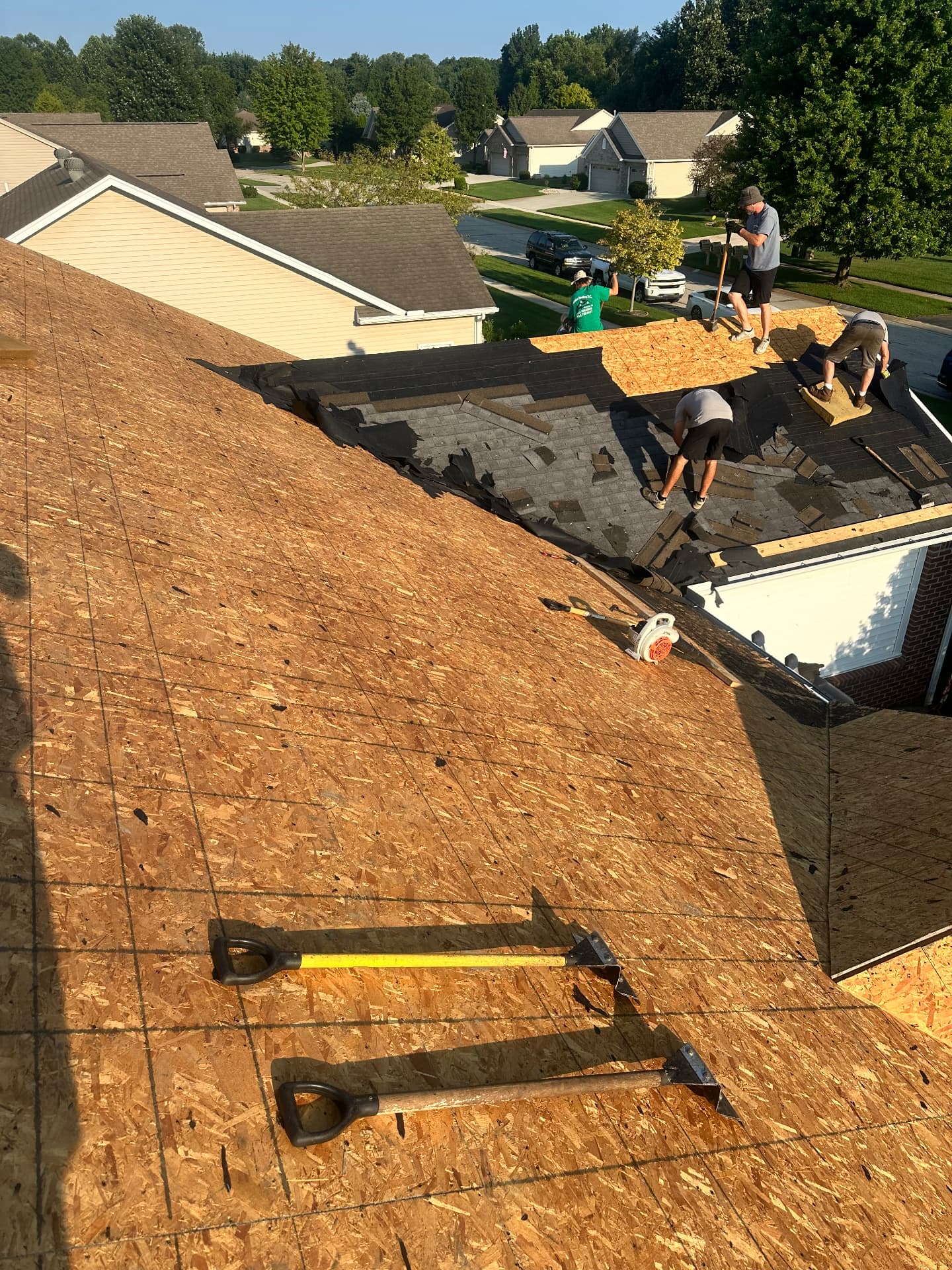 Crew stripping old shingles down to deck — Dundee, MI
